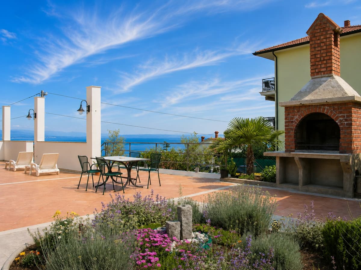 Sun terrace with loungers, a brick barbecue and a lavender garden